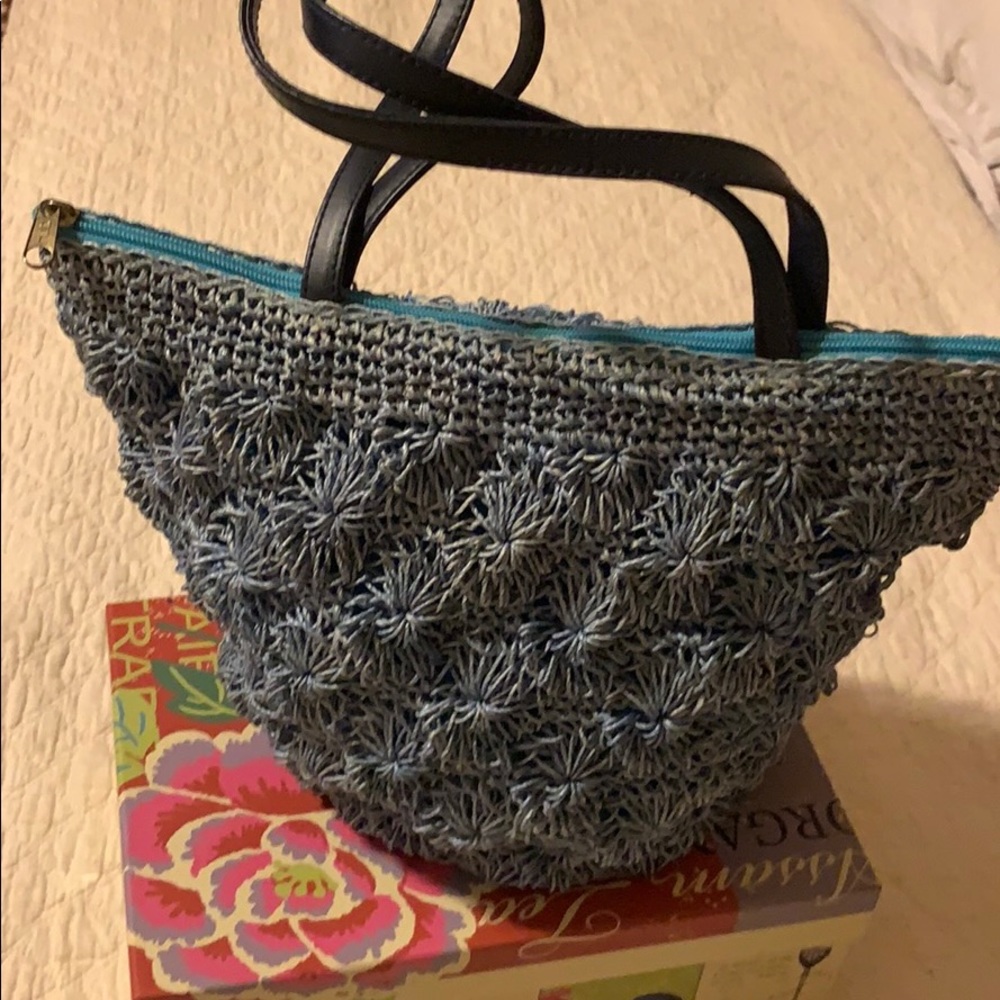 Blue woven bag with zipper and a pocket inside